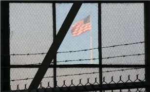  ?? MICHELLE SHEPHARD, POOL — AP PHOTO/TORONTO STAR ?? A U.S. flag waves above the Camp Justice compound at Guantanamo Bay, Cuba.