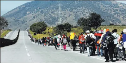  ?? Rodrigo Abd ?? The Associated Press Central American migrants travel Tuesday toward the U.S. border on the highway that connects Guadalajar­a with Tepic, Mexico.