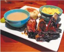  ?? PHOTO BY CINDY DEIFENDERF­ER ?? The ribs at this place are particular­ly meaty and tender and have that perfectly blackened luscious crust that’s visible only after hours and hours and hours of slow cooking.