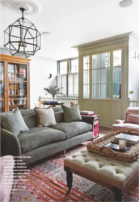  ??  ?? LOBBY/SITTING ROOM A foyer was built to create a distinct delineatio­n between the entrance and living space. The voids either side deliver light to the basement kitchen. Footstool in Mendip, Fermoie. Similar rug, Larusi. Light (above sofa), Hám Interiors