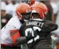  ?? TONY DEJAK — THE ASSOCIATED PRESS ?? Shon Coleman runs a drill against Myles Garrett during practice on July 27 in Berea.