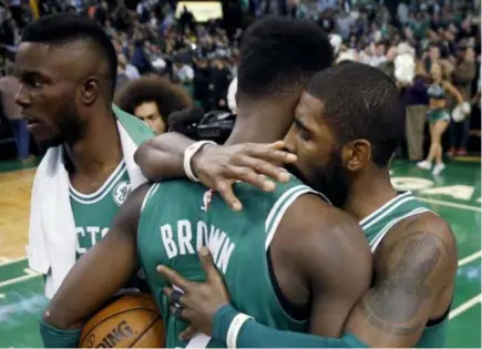  ?? AP Photo ?? STREAK GOES ON. Boston Celtics’ Kyrie Irving, right, hugs teammate Jaylen Brown (7) after defeating the Golden State Warriors, 92-88, during an NBA game in Boston.