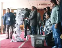  ??  ?? A Nepalese election commission officer empties a ballot box prior to counting the votes in Katmandu on Friday. (AP)