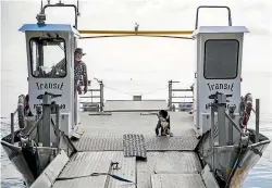  ?? ?? Craig Aston and border collie Squidward work another barge sailing.