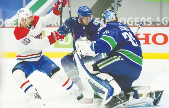  ?? JONATHAN HAywARD/THE CANADIAN PRESS ?? Canucks defenceman Tyler Myers stops Canadiens winger Tomas Tatar from getting a shot on goalie Thatcher Demko Thursday at Rogers Arena.