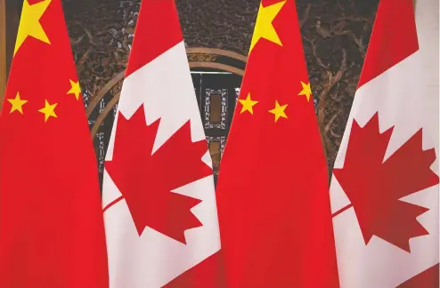  ??  ?? Canadian and Chinese flags fly side by side in the Diaoyutai State Guesthouse in Beijing. The Canadian government is concerned about the
Hong Kong government's decision to require dual nationals to declare the nationalit­y they wish to legally maintain while in Hong Kong.
