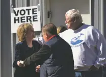  ?? DONNA CAMPBELL/DAILY LEADER VIA AP ?? GOP U.S. Sen. Cindy Hyde-Smith, left, greets neighbors at her Brookhaven, Miss., precinct after voting Tuesday in her runoff race against Democrat Mike Espy.