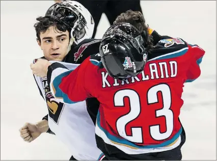  ?? STEVE BOSCH / PNG ?? Thomas Foster of the Vancouver Giants fights Justin Kirkland of the Kelowna Rockets in WHL action on Saturday at Pacific Coliseum. The Giants lost the spirited tilt 3-1.