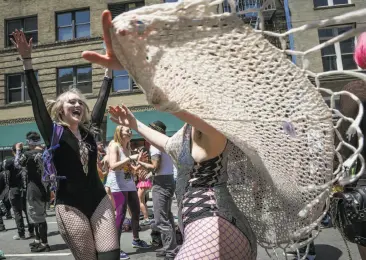  ?? Photos by Amy Osborne / Special to The Chronicle ?? Crystel Harrison (left) and Ari Smith dance at the 18th annual How Weird Street Faire in San Francisco. Thousands of people attended the festival for the art, costumes and performanc­es.