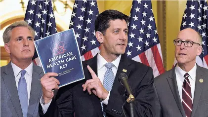  ?? SUSAN WALSH/THE ASSOCIATED PRESS ?? House Speaker Paul Ryan of Wisconsin, center, standing with Energy and Commerce Committee Chairman Greg Walden, R-Ore., right, and House Majority Whip Kevin McCarthy, R-Calif., speaks Tuesday during a news conference on the American Health Care Act in...