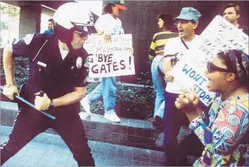  ?? Kirk McKoy Los Angeles Times ?? AN LAPD OFFICER uses his baton on a protester at 1st Street and Broadway downtown during the 1992 riots. At the time, young officers were trained in old-school ways — chokeholds, hogtying, a wartime mentality.