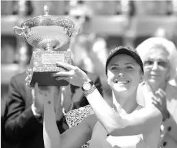  ??  ?? Ukraine’s Elina Svitolina poses with the trophy after winning the women’s final against Romania’s Simona Halep at Rome’s WTA Tennis Open tournament at the Foro Italico, on May 20, 2018 in Rome. — AFP photo