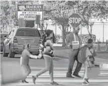  ?? Mark Mulligan / Houston Chronicle ?? Students at the damaged Braeburn Elementary School are being bused to the former DeBakey High School 11 miles away and returned to dropoff points, including at the vacant campus.