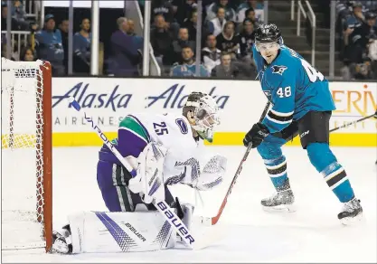  ?? JOSIE LEPE — STAFF PHOTOS ?? The Sharks’ Joe Thornton, right, scores a power-play goal against Vancouver Canucks goalie Jacob Markstrom on Thursday night.