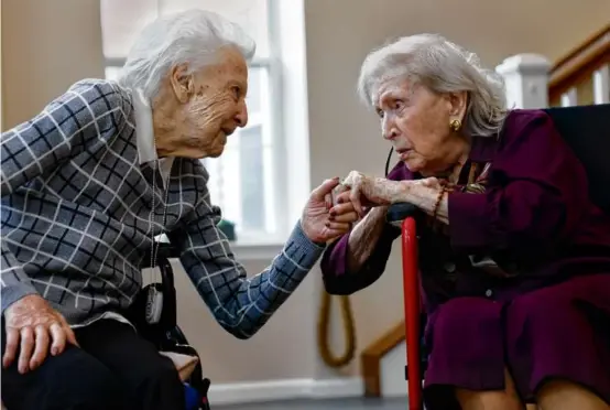  ?? PHOTOS BY JESSICA RINALDI/GLOBE STAFF ?? Barbara Long (left) and Marion Cronin, both born on Feb. 7, 1921, chatted after jointly being awarded on Tuesday the Boston Post Cane (top) for Rye, N.H.