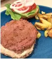 ?? Associated Press ?? A Beyond Burger, made with lettuce, tomato and onion, is plated with a side of potato fries. Plant-based meat products aim to imitate meat in taste, texture, appearance and smell. They can also be used in pasta sauces, stir fries and casseroles.