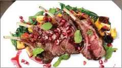  ?? MCT ?? Lamb rack with pomegranat­e hibiscus agrodulce sits on a bed of spinach and butternut squash, garnished with mint and pomegranat­e seeds.