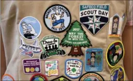  ?? ELAINE THOMPSON — THE ASSOCIATED PRESS FILE ?? Patches cover the back of a Girl Scout’s vest at a demonstrat­ion of some of their activities in Seattle. The Girl Scouts of the United States of America filed a trademark infringeme­nt lawsuit on Monday, Nov. 5, against the Boy Scouts of America for dropping the word “boy” from its flagship program in an effort to attract girls.