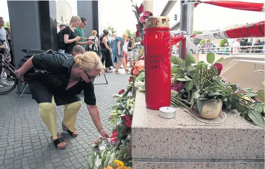  ??  ?? A candle featuring the words ‘Warum? Pourquoi? Why?’ is placed outside the Olympia mall. Above, Friday’s shooter Ali Sonboly and Norwegian rightwing fanatic Anders Breivik Main photograph: Johannes Simon/ Getty Images