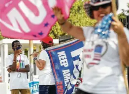  ?? Jon Shapley / Staff photograph­er ?? Malachi Hollis, 17, left, talks with Awilda LopezDeVic­toria, center, as Emely McHattie, right, campaigns for Donald Trump on Oct. 18 in Houston.