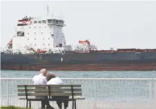  ?? DAN JANISSE ?? The Algoma Equinox freighter moves east on the Detroit River near
Belle Isle, Michigan, on Tuesday. It's been 20 years since the Detroit River was given a heritage designatio­n by Canada.