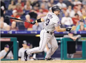  ?? MATT SLOCUM/ASSOCIATED PRESS ?? Colorado’s Tom Murphy watches one of his three hits during Tuesday night’s 6-4 loss at Philadelph­ia. Murphy went 3-for-4 with a double and two RBIs after being called up from Albuquerqu­e.