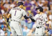  ?? HARRY HOW — GETTY IMAGES ?? Jose Altuve and Carlos Correa of the Houston Astros celebrate taking a lead in the 10th inning Wednesday night. The Astros eventually won the game in 11innings, 7-6.