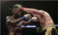  ?? MARK J. TERRILL - THE ASSOCIATED PRESS ?? Deontay Wilder, left, and Tyson Fury, of England, trade punches during a WBC heavyweigh­t championsh­ip boxing match, Saturday, Dec. 1, 2018, in Los Angeles.
