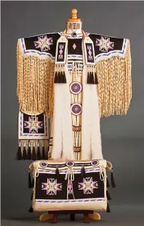  ??  ?? Beverly Bear King Moran (Standing Rock Lakota) Dakota Night Sky Girl’s Northern Traditiona­l buckskin dress with possible bag Dress 38 × 32 inches