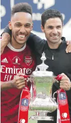 ?? POOL VIA AP ?? Arsenal's Pierre-Emerick Aubameyang, left, and head coach Mikel Arteta with the trophy after Saturday’s game.