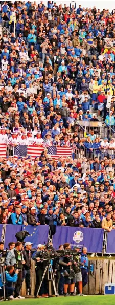  ??  ?? All eyes on Tony Finau: the American hits the first tee shot of the Ryder Cup as the morning fourballs get under way in front of the huge stand packed with supporters