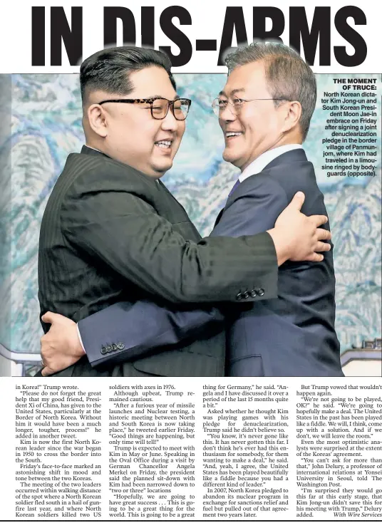  ??  ?? North Korean dictator Kim Jong-un and South Korean President Moon Jae-in embrace on Friday after signing a joint denucleari­zation pledge in the border village of Panmunjom, where Kim had traveled in a limousine ringed by bodyguards (opposite). THE...