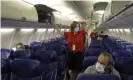  ?? ?? A Southwest Airlines flight attendant prepares a plane bound for Orlando, Florida, for takeoff at Kansas City internatio­nal airport in May 2020. Photograph: Charlie Riedel/AP