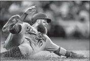  ?? Greg Fiume Getty Images ?? JUSTIN TURNER SCORES on a single by Cody Bellinger in the seventh inning for a 6-2 Dodgers lead.