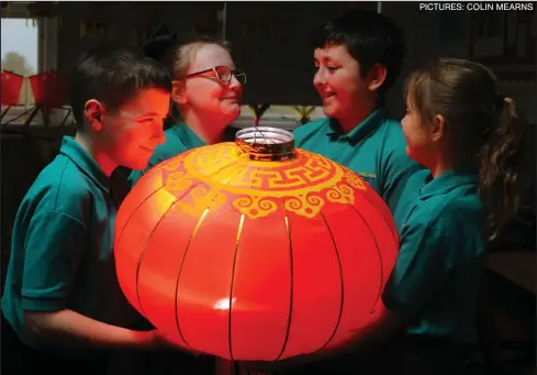  ??  ?? Logan Forsyth, 11, Sophie McGarracha­n, 10, Callum Greene, 11, and Camy Craigon, 10, of King’s Park Primary prepare for the Chinese New Year