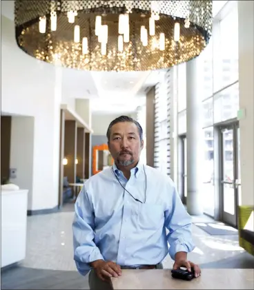  ?? PATRICK TEHAN — STAFF PHOTOGRAPH­ER ?? Mike Kim, of San Francisco-based Simeon Properties in the lobby at Centerra, a luxury tower in downtown San Jose. He plans to break ground for another tower in downtown next spring.