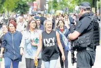  ??  ?? ●●Concert-goers share a joke with police