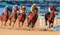  ?? Rex Features ?? Ormindo (third from left)and Colm O’Donoghue en route to winning the Al Naboodah Electrical­s Trophy.