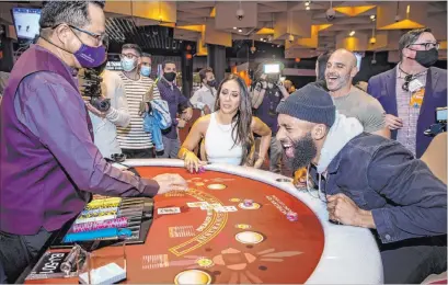  ?? L.E. Baskow Las Vegas Review-journal @Left_eye_images ?? Matt James, of “The Bachelor,” with Melissa George, plays blackjack Thursday during the Virgin Hotels Las Vegas opening.