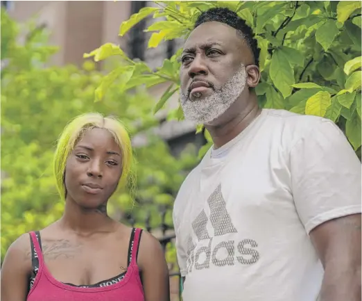  ?? PAT NABONG/SUN-TIMES ?? Laurentio Howard and his daughter, Dnigma Howard, 18, outside their Near West Side home.