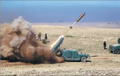  ?? KHALID AL-MOUSILY / REUTERS ?? Members of the Iraqi rapid response forces fire a missile toward Islamic State militants during a battle in the south of Mosul, Iraq on Sunday.