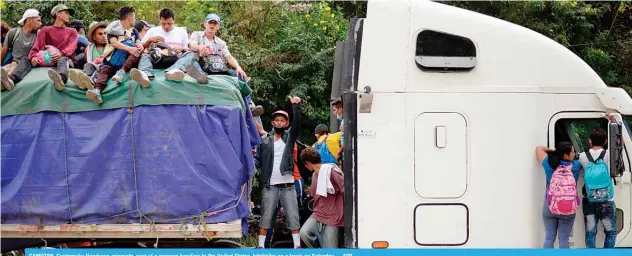  ??  ?? CAMOTAN, Guatemala: Honduran migrants, part of a caravan heading to the United States, hitchhike on a truck on Saturday. —AFP