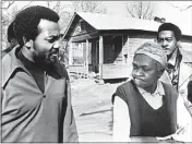  ?? AP FILE PHOTO ?? Former football great Jim Brown, left, president of the Black Economic Union, confers with Mrs. Anne Faulkner, 74, in her poor neighborho­od at Holly Springs, Miss., Feb. 11, 1970. Brown led about 25 black athletes for the firsthand look at conditions his BEU hopes to improve. In the background is Leroy Kelly of the Cleveland Browns.