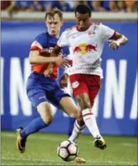  ?? JOHN MINCHILLO — THE ASSOCIATED PRESS FILE ?? Red Bulls midfielder Tyler Adams, right, shields the ball against FC Cincinnati midfielder and Malvern native Jimmy McLaughlin, left, during a U.S. Open Cup semifinal match in Cincinnati.