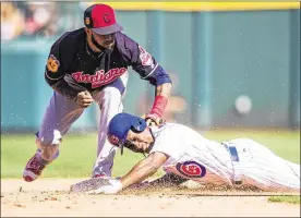  ?? ROB TRINGALI / GETTY IMAGES ?? The Cubs’ Jemile Weeks steals second as the Indians’ Ronny Rodriguez is late with the tag in Mesa, Ariz. Sunday’s World Series rematch ended in a tie.