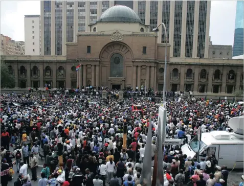  ??  ?? A DECADE AGO: Jacob Zuma’s supporters stand outside the high court in Joburg, waiting for him to address them, after his first court appearance on a charge of rape in 2006.