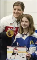  ??  ?? Olympic hockey star Laura Fortino poses with Sarah Rabak, 10, who plays for Ancaster.