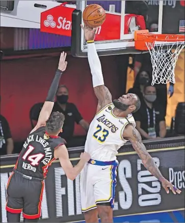  ?? Wally Skalij Los Angeles Times ?? L e BRON JAMES, blocking the shot of the Heat’s Tyler Herro, was up for the challenge in Game 3 of the NBA Finals, but his Lakers teammates suffered a letdown. Now they have a close series, leading two games to one.