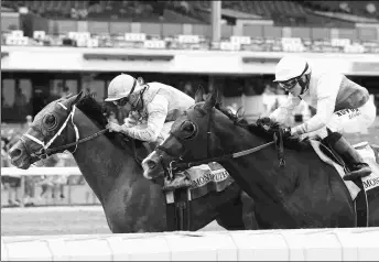  ?? BILL DENVER/EQUI-PHOTO ?? Mandaloun (left) seemingly had the Pegasus won in hand but then had to hold off a resurgent Weyburn. Brad Cox said he may have shut down after making the lead.