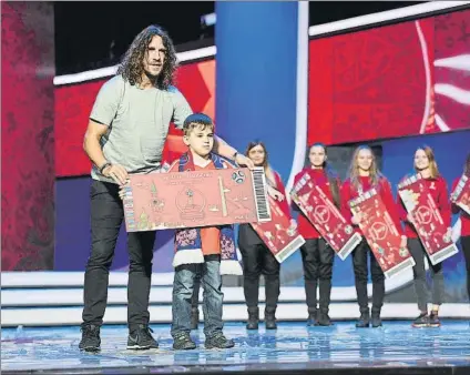  ?? FOTO: GETTY ?? Carles Puyol posa junto a unos niños tras un ensayo del sorteo de la fase final del Mundial de Rusia-2018